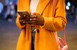 © Hernandez & Sorokina/Stocksy - Woman Hands Holding Phone Outdoors At Night