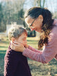 © Serena Burroughs/Stocksy - Grandmother holding her grandson's face in her hands