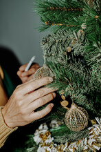 Smoking A Cigarette While Is Decorating The Christmas Tree