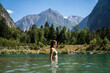 © Alba Vitta/Stocksy - Woman swimming in mountain lake
