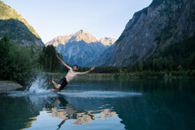 Man Jumping Into Mountain Lake