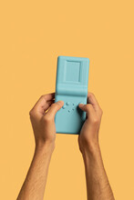 Hands Holding And Playing On Handheld Game Console