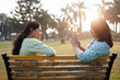 © Saptak Ganguly/Stocksy - Two middle aged women spending leisurely time together in the park