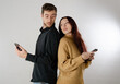© Laia Balart - Jealous boyfriends looking at the mobile. Both spy on and control each other. Concept of jealousy in a couple and mistrust. Background isolated on white background.