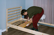 © Duet Postscriptum/Stocksy - A young man assembles a wooden bed