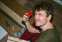 A Young Man With A Screwdriver