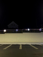Empty Parking Lot At Dark Night With Star Decoration And Wall