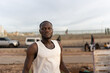 © Alvaro Lavin/Stocksy - portrait of man on beach promenade in senegal