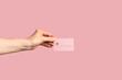 © Pixel Stories/Stocksy - Hand holding credit / debit card