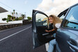 © Michela Ravasio/Stocksy - Woman getting out of the car