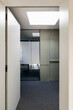 © Koen Van Damme/Stocksy - doorway in office building