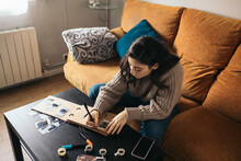 Woman Making A Scrapbook With Polaroid Photos