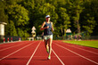 © Cavan Images - A woman running on a track.