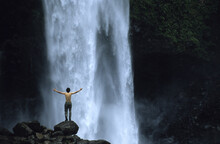 Man Standing Near A Waterfall, Banos, Ecuador.