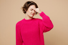 Young Sick Ill Sad Puzzled Caucasian Woman Wearing Pink Sweater Keep Eyes Closed Rub Put Hand On Nose Think Isolated On Plain Pastel Light Beige Background Studio Portrait. People Lifestyle Concept.
