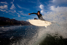 A Skilled Male Surfer Launches An Air.