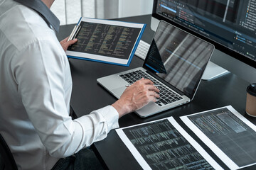 Male programmer working on website project in software development on the desktop computer and making coding and typing data code password security
