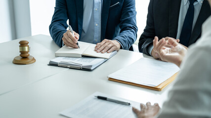 Wall Mural - Businesspeople and Male lawyer consult and conference having team meeting with the client at a law firm in office, Law and Legal services concept