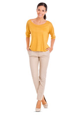 a full length shot of a casually dressed young woman standing with her hands in her pocket isolated 