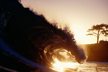 View Of The Inside Of A Crashing Wave Shot At Sunset In Santa Cruz, California.
