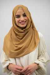 Wall Mural - Portrait of young muslim woman wearing hijab on isolated white background