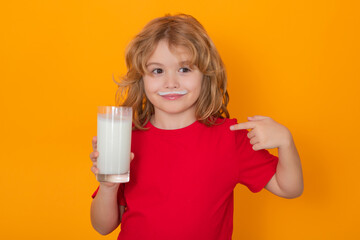 Wall Mural - Healthy food for kids. Organic milk. Cute little child with glass of milk on studio color background. Kid with milk moustache. Fun portrait of cute kid with white milk mustache and funny face.