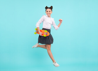 Canvas Print - Teen hipster girl skater with skateboard on isolated background. Jump and run. Summer kids trend, urban teenage style.