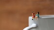 © Muchlis Nugroho - Miniature figures of 2 women talking over glasses. discussion concept.