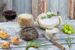 Corsican traditional varity of goat and sheep cheese and glass of red vine on wood background