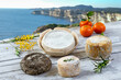Local wild pork delicatessen, and corsican cheese, sea landscape background