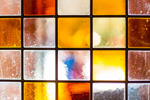 Lead-lined Colourful Chequered Stained Glass In Victroian Pub Window Full Of Imperfections. Background.