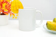 A white blank tea mug with a slice of star fruit attached to the edge of the mug minimalist fresh concept