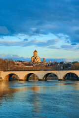 Wall Mural - Sunset on the waterfront in Tbilisi overlooking the bridge and the temple