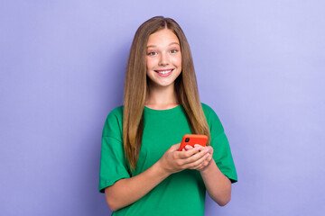 Sticker - Photo of cute cheerful lady wear stylish green clothes hold modern device quality modern technology isolated on purple color background