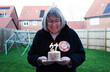 © Cavan Images - lady celebrating her 72nd birthday with a cake and candles