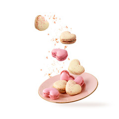 Wall Mural - French sweet colorful heart shape cookies macarons macaroons with crumbs flying falling on vintage pink plate