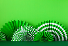 St Patricks Day Paper Fans On Green Background
