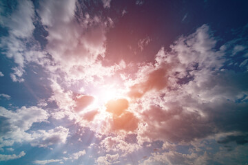 Wall Mural - sunbeams of a bright sun in a cloudy sky