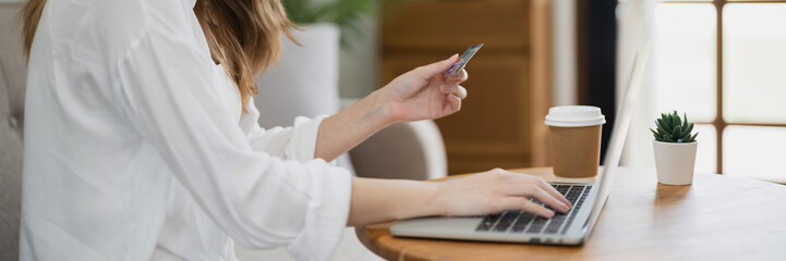 Wall Mural - Happy asian woman using laptop and credit card for online payment, E-commerce