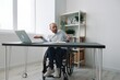 © SHOTPRIME STUDIO - A man in a wheelchair a businessman in the office works, severe fatigue and emotional burnout, anger, integration into society, the concept of work a person with disabilities