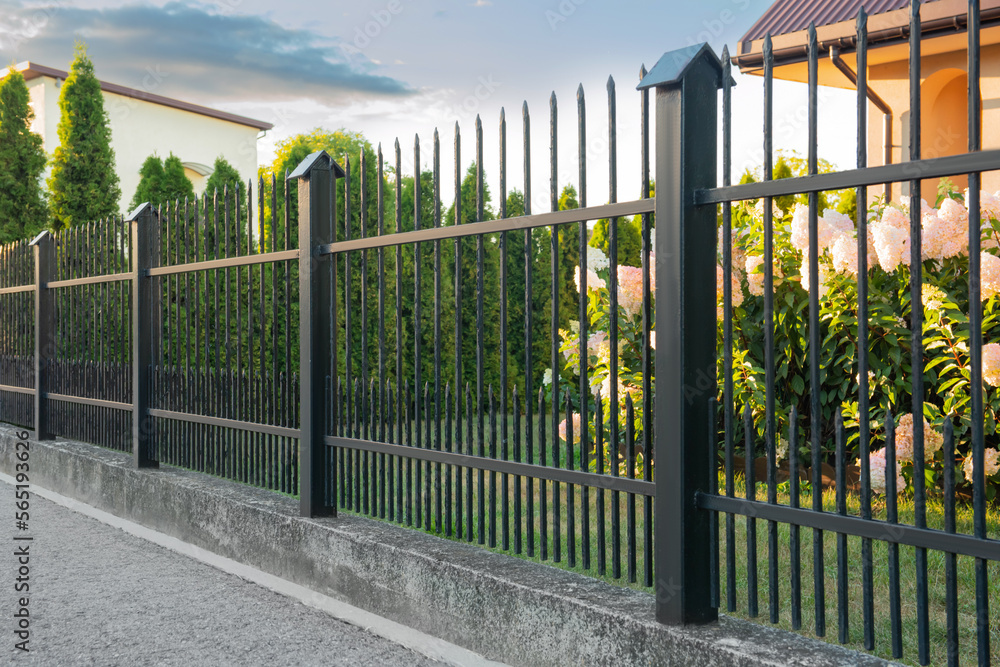 Beautiful black iron fence near pathway outdoors Stock Photo | Adobe Stock