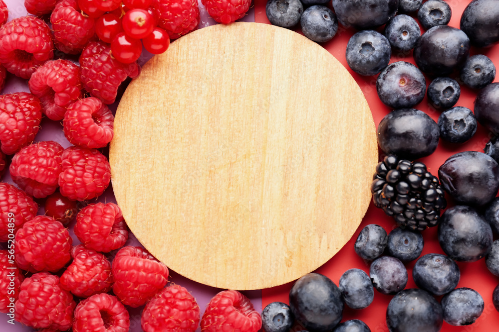 Composition with wooden board and fresh berries, closeup