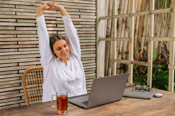 Young business woman sit indoors in co working using laptop computer.