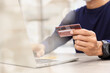 © A Stockphoto - Businessman holding credit card for online shopping bill on smartphone, positive man shopping online remote payment , smart payment concept individual bank