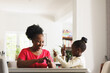 © Wavebreak Media - Happy african american grandmother and deaf granddaughter using sign language