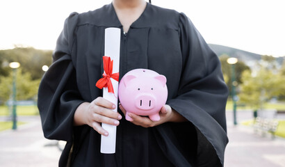 Poster - Piggy bank, saving and university diploma in hands of woman graduate with education scroll. Study paper, scholarship and college trust fund of a woman hand at college event with money for future