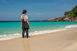 © Noppasinw - Tropical islands view of woman tourist looking at ocean blue sea water and white sand beach, Phang Nga Thailand nature landscape
