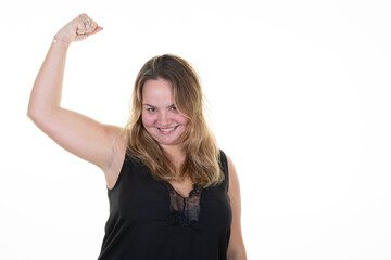 Wall Mural - Smiling young blond plus size body positive female woman girl showing biceps muscles looking camera on white background studio portrait