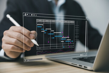 Fototapete - Male manager managing business planning project schedule in the office. Gantt chart showing on virtual screen.	
