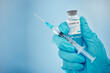 © Jesse B/peopleimages.com - Doctor, hands and covid vaccine for cure, healthcare or medical syringe medication to combat the virus. Hand of nurse holding corona virus sample with needle for vaccination from illness or disease
